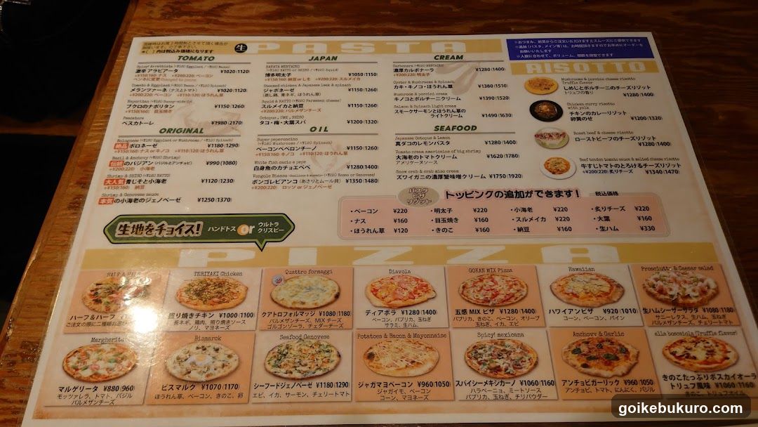 A printed menu featuring sections like PASTA, RISO TTO, SEAFOOD, and various pasta dishes with prices in yen.