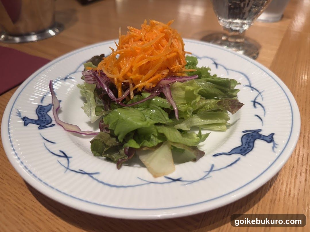 Salad with shredded carrots and lettuce on a decorative plate