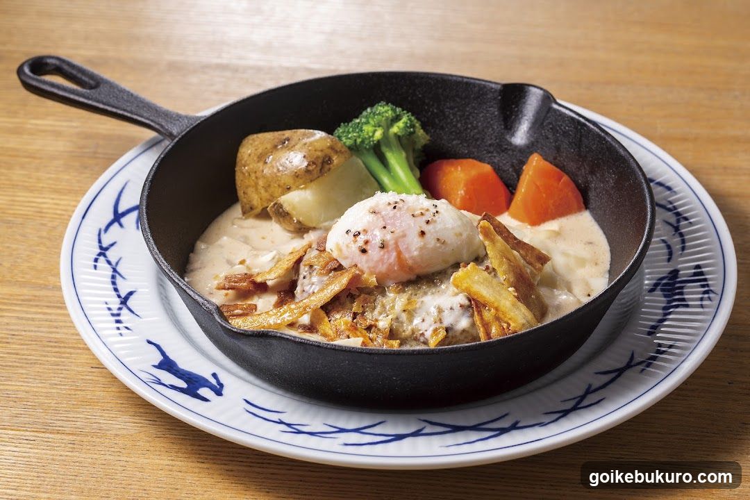 Cast Iron Skillet Meal with Poached Egg and Creamy Sauce