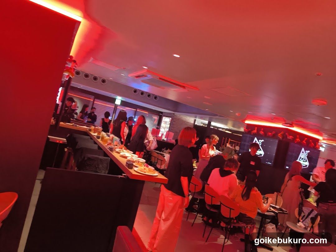 Red-lit bar interior with patrons
