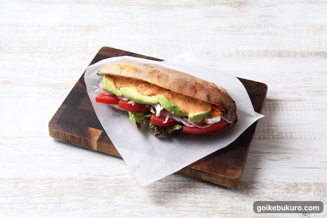 Avocado and Tomato Sandwich on Wooden Board