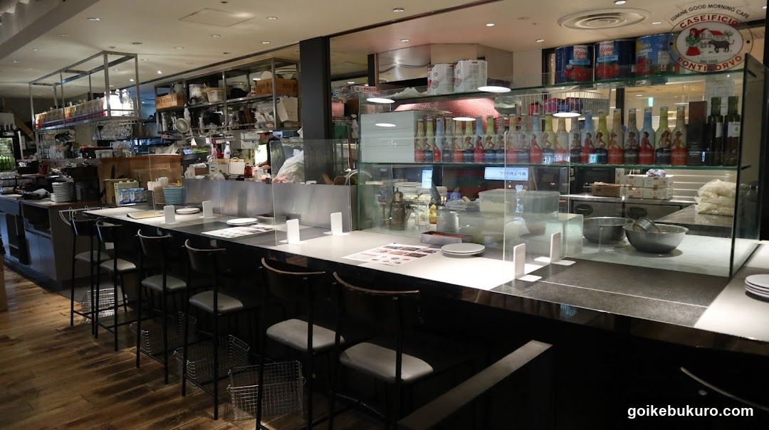 Restaurant Interior with Bar Counter and Kitchen View