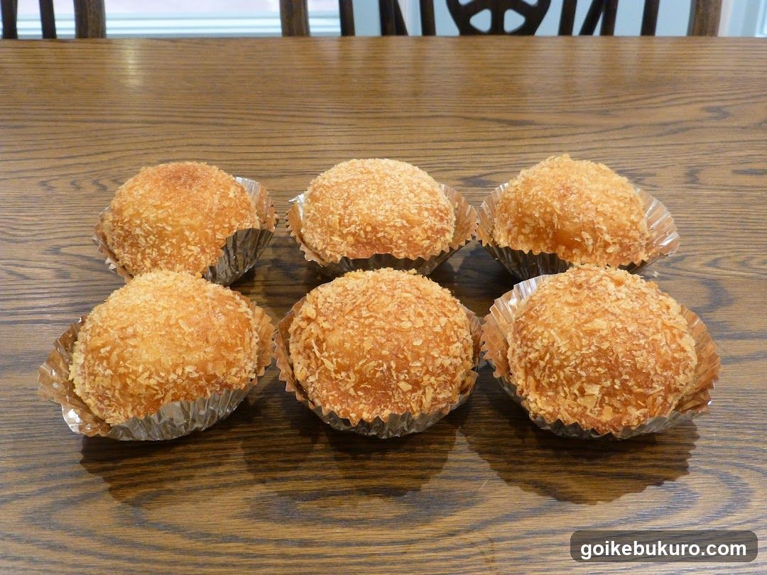 Coconut-Crusted Muffins on a Wooden Table