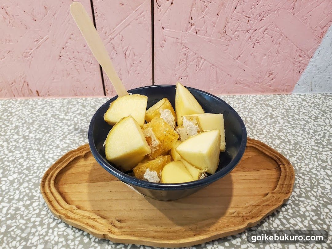 Bowl of pineapple chunks with popsicle stick