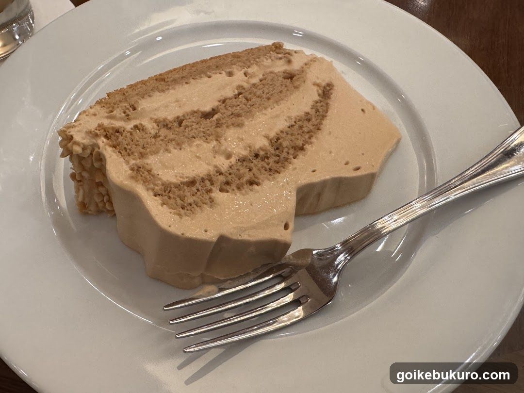 Slice of layered cake on a white plate with fork