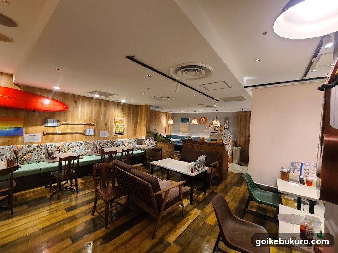 Interior of a cozy restaurant or cafe with wooden decor and tropical-themed seating.