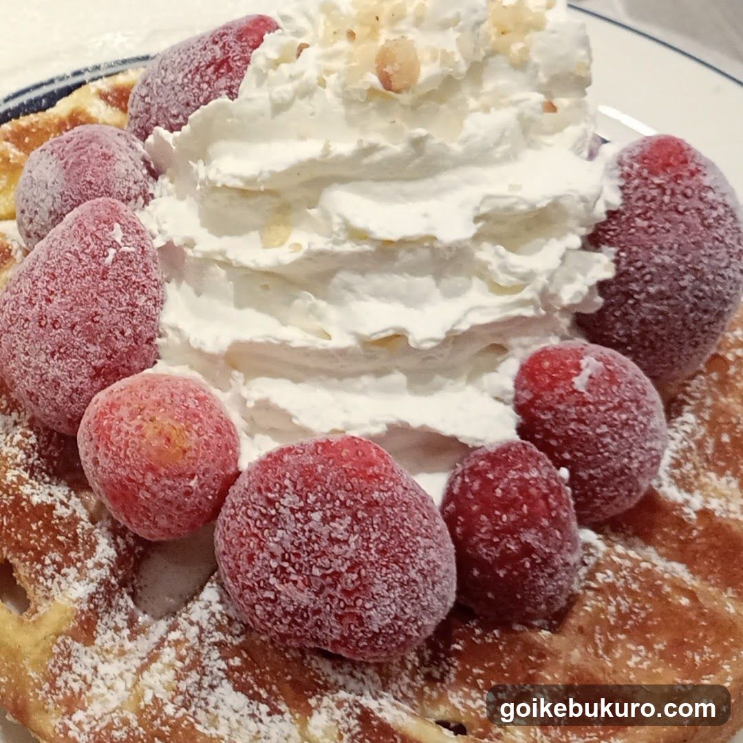 Waffle with whipped cream and strawberries