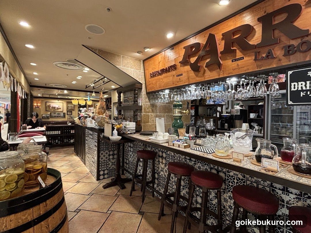 Interior of a bar or restaurant with hanging meat and glassware display