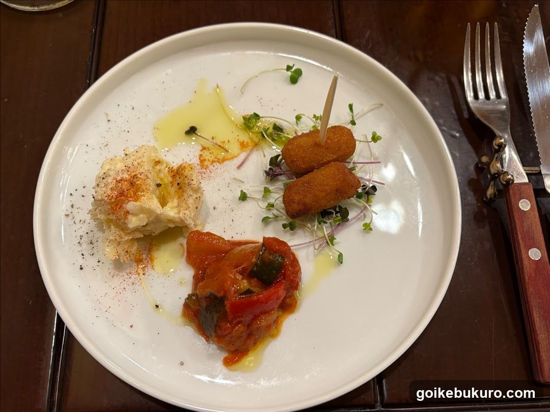 Plated Food Dish with Croquettes and Sauce