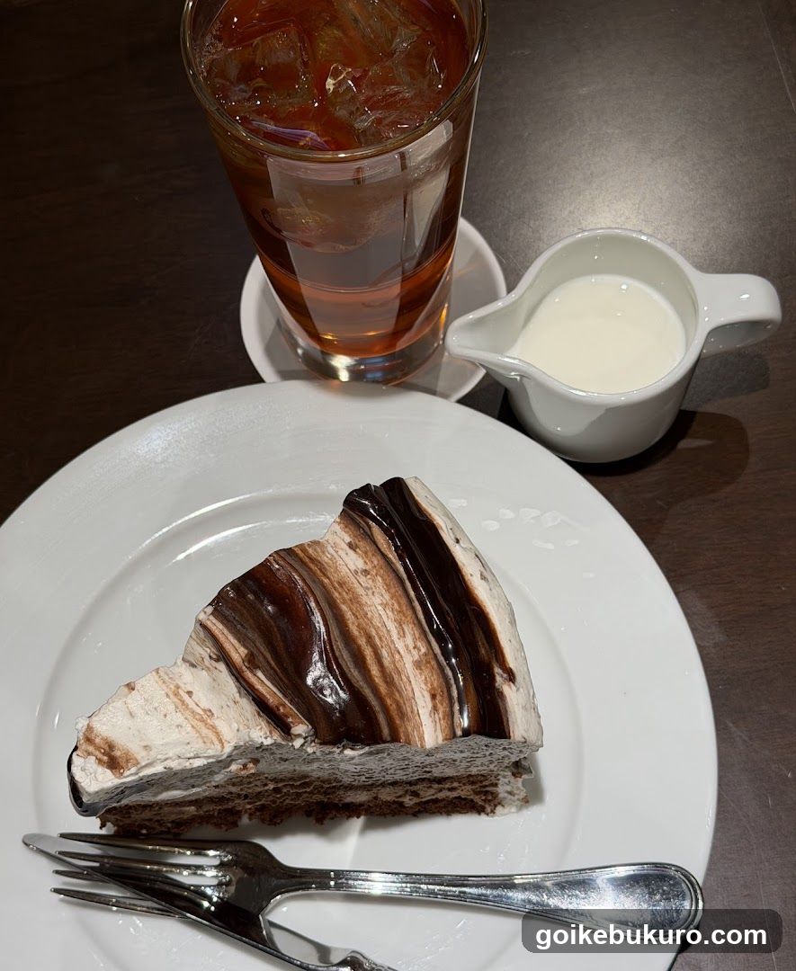 Slice of Chocolate Cake with Iced Tea and Creamer