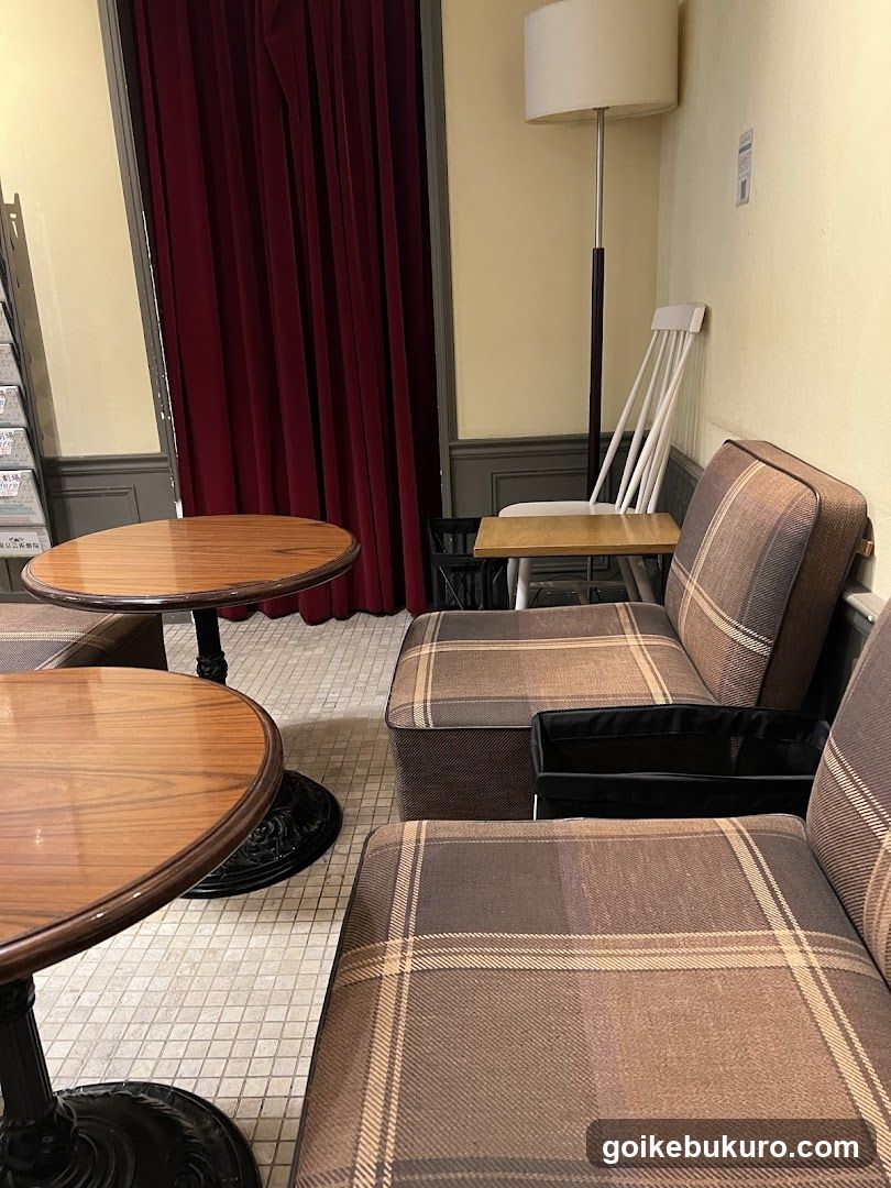 Interior seating area with plaid sofas and wooden tables