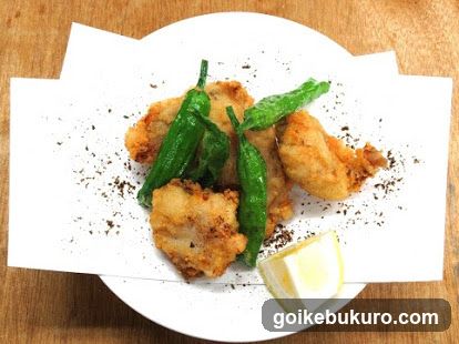 Fried Fish with Green Peppers and Lemon Wedge