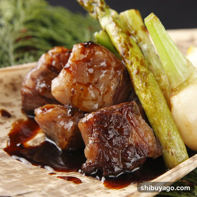 Sauced Meat with Asparagus and Celery on Wooden Plate