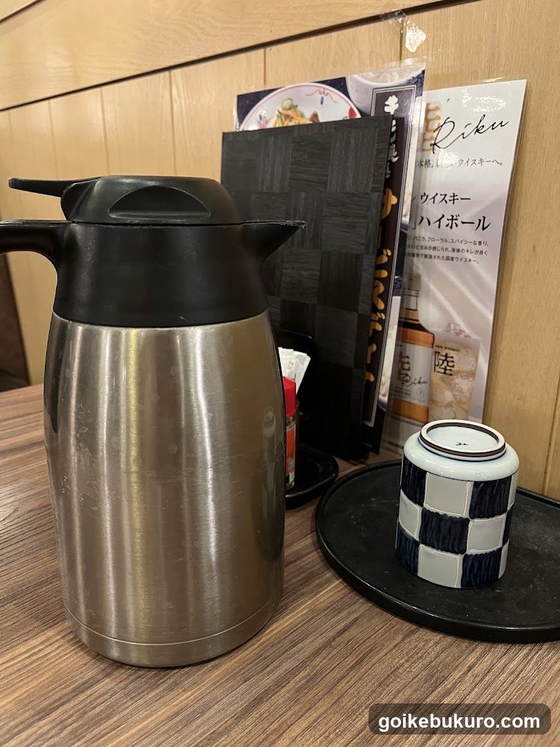 Thermos and Ceramic Cup on Table