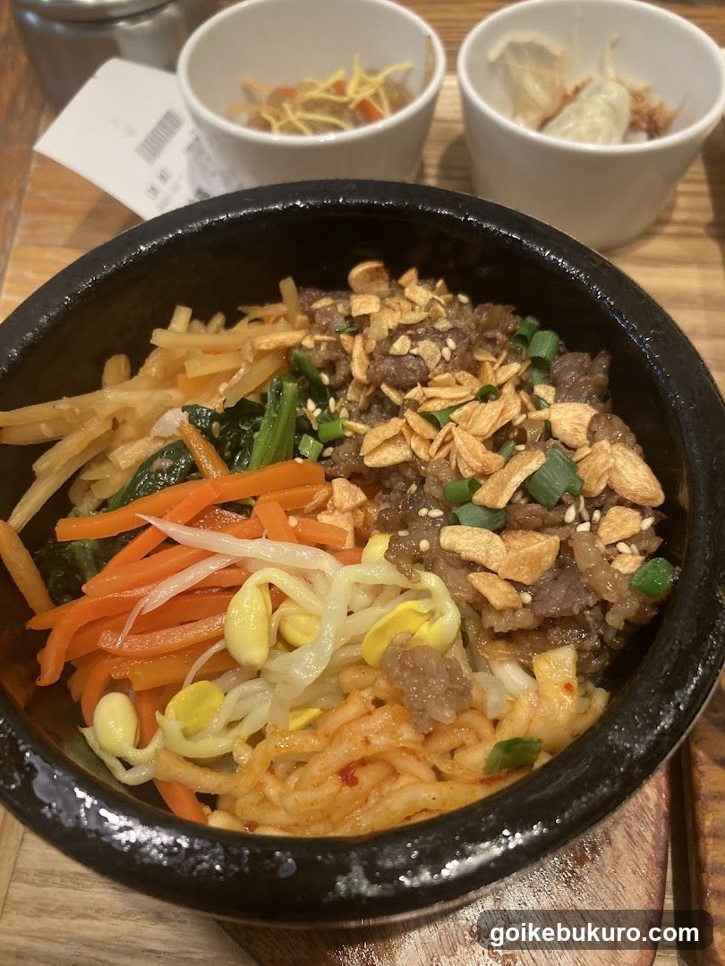 Bowl of Korean-style rice with toppings and side dishes