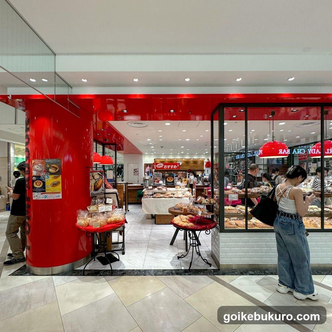 Bakery Store Interior with Display Tables and Customers