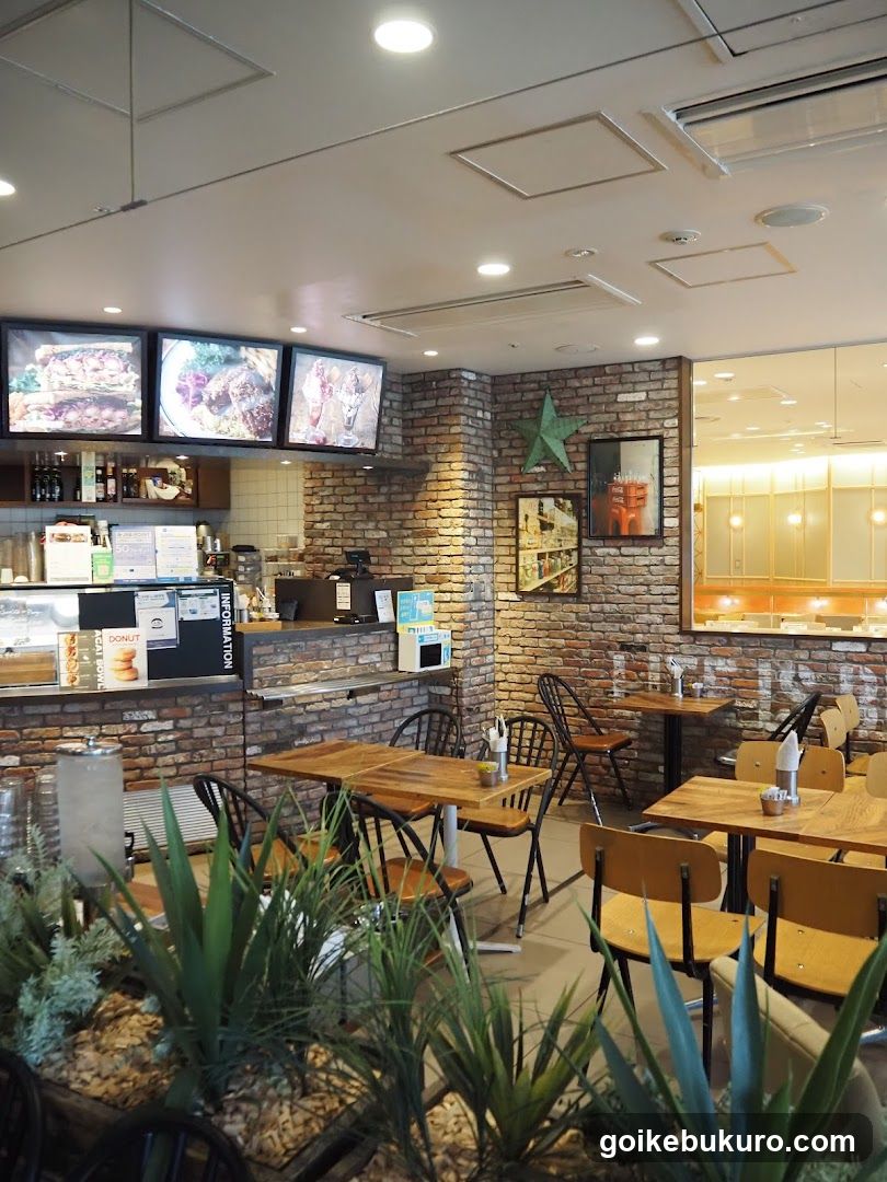 Interior of a cafe with brick walls and menu screens