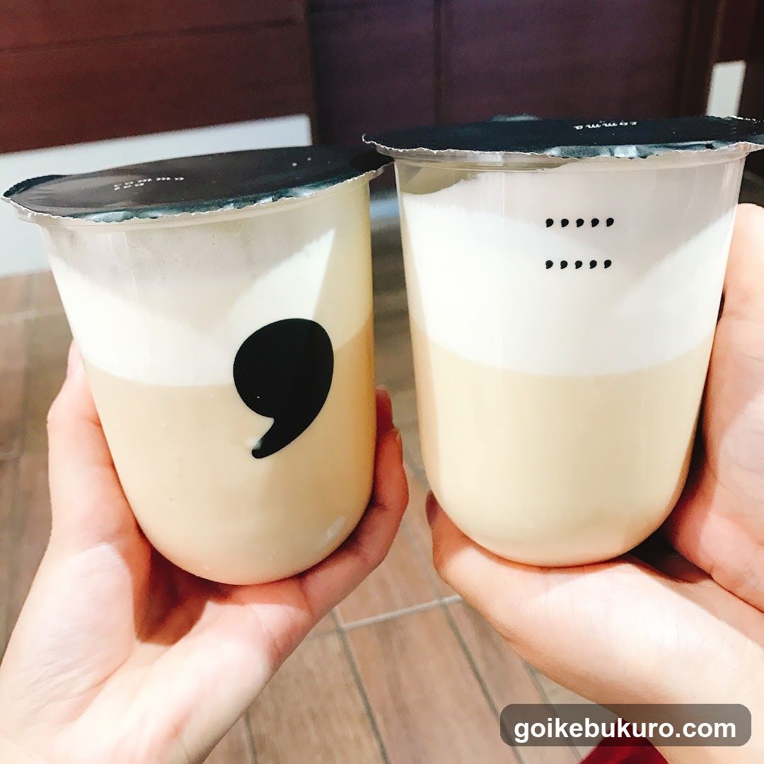 Two hands holding bubble tea cups