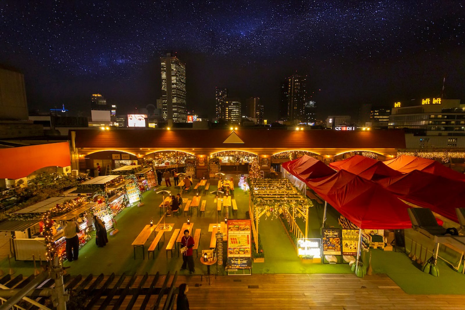 Sky Deck Christmas Market from above — stalls, red tents, Ikebukuro skyline